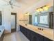 Bright bathroom featuring a standalone tub beneath a decorative window and dual vanity at 4837 Mystere Cir, Lilburn, GA 30047