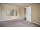 Bedroom with neutral walls, carpet flooring, and a doorway leading to another room at 4837 Mystere Cir, Lilburn, GA 30047