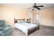 Relaxing bedroom with carpet, ceiling fan, and a cozy seating area for comfortable living at 4837 Mystere Cir, Lilburn, GA 30047