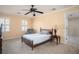 Serene bedroom with neutral carpet, ceiling fan, shutters, and ample space for relaxation at 4837 Mystere Cir, Lilburn, GA 30047