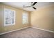 Bedroom with carpet flooring, neutral walls, ceiling fan and natural light through the windows at 4837 Mystere Cir, Lilburn, GA 30047