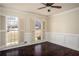 Comfortable bedroom with hardwood floors, wainscoting, shuttered windows, and ceiling fan at 4837 Mystere Cir, Lilburn, GA 30047