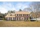 Charming brick two-story home with a well-manicured lawn and classic black shutters at 4837 Mystere Cir, Lilburn, GA 30047