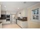 Bright kitchen featuring white cabinetry, granite countertops, and stainless steel appliances at 4837 Mystere Cir, Lilburn, GA 30047