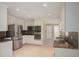 Modern kitchen with stainless steel refrigerator, built-in microwave and oven, and granite counters at 4837 Mystere Cir, Lilburn, GA 30047