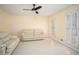 Cozy living room with tile floors, a ceiling fan, and shuttered windows providing natural light at 4837 Mystere Cir, Lilburn, GA 30047