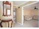 Bright living room with tile flooring, neutral walls, decorative mirror, and adjacent seating area at 4837 Mystere Cir, Lilburn, GA 30047