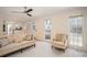 Open living area with tile floors connecting to the kitchen and featuring large windows for natural light at 4837 Mystere Cir, Lilburn, GA 30047