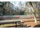 Outdoor tennis courts surrounded by trees and a chainlink fence at 4837 Mystere Cir, Lilburn, GA 30047