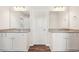 Modern bathroom with dual vanities featuring granite counters and white cabinetry at 2027 Wyndham Pl, Conyers, GA 30013