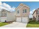 Beautifully designed home with a two-car garage, brick and siding combination, and a green lawn at 2027 Wyndham Pl, Conyers, GA 30013