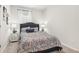 Comfortable bedroom featuring neutral tones, a plush bed, decorative pillows, and light-enhancing curtains at 2029 Wyndham Pl, Conyers, GA 30013