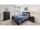 bedroom featuring stylish furniture, themed bedding, and soft lighting at 2029 Wyndham Pl, Conyers, GA 30013