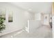 Well-lit hallway with neutral tones and plush carpeting leading to other areas of the home at 2029 Wyndham Pl, Conyers, GA 30013