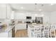 Modern kitchen showcasing white cabinetry, stainless steel appliances, granite countertops, and island with seating at 2029 Wyndham Pl, Conyers, GA 30013