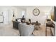 Cozy living room featuring a gray sofa set, a large clock, and a lamp at 2029 Wyndham Pl, Conyers, GA 30013