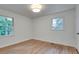 Bright bedroom with hardwood floors, white walls, and two windows at , Atlanta, GA 30329