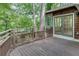 An upper level wooden deck with a railing overlooks a yard full of mature trees at , Atlanta, GA 30329