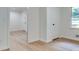 Hallway with hardwood floors, white walls, and doors at , Atlanta, GA 30329