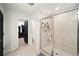 Bright bathroom featuring glass shower and views of the toilet and walk-in closet at 1120 Sunny Lake Dr, Lawrenceville, GA 30043