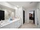 Modern bathroom with dual sinks, a large mirror, neutral tile flooring, and a separate shower at 1120 Sunny Lake Dr, Lawrenceville, GA 30043