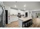 Well-lit kitchen featuring white cabinets, stainless steel appliances, and a center island at 1120 Sunny Lake Dr, Lawrenceville, GA 30043