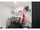 Well-organized laundry room with modern washer and dryer, storage shelves, and functional layout for efficient chores at 1120 Sunny Lake Dr, Lawrenceville, GA 30043