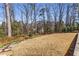 Large backyard with manicured lawn, stone pathway, and mature trees offering privacy at 2109 Rugby St, Atlanta, GA 30309