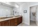 Spacious bathroom with double sink vanity, dark wood cabinets, and walk-in closet at 2109 Rugby Ave, Atlanta, GA 30337