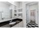 Elegant bathroom featuring black and white tile, built-in shelving, and shower at 2109 Rugby Ave, Atlanta, GA 30337