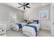 Light-filled bedroom with twin beds, white wainscoting, and window at 2109 Rugby St, Atlanta, GA 30309