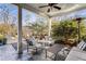 Cozy covered patio featuring slate tile floor, ceiling fan, comfortable seating, and access to a hot tub at 2109 Rugby St, Atlanta, GA 30309