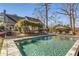 Stunning in-ground pool with a tanning ledge, complemented by an outdoor dining area and beautiful landscaping at 2109 Rugby Ave, Atlanta, GA 30337