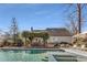 Beautiful backyard view of the in-ground pool, outdoor dining under a pergola, and lush landscaping at 2109 Rugby St, Atlanta, GA 30309