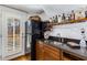 Stylish wet bar features granite counters, a stainless sink, black refrigerator, and attractive wine storage at 2109 Rugby Ave, Atlanta, GA 30337