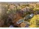 Aerial view showcases the home's location surrounded by lush greenery and mature trees in a quiet neighborhood at 2490 Brookcliff Ne Way, Atlanta, GA 30345