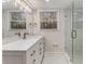 Modern bathroom features a dual sink vanity, beautiful mirror and a glass enclosed shower at 2490 Brookcliff Ne Way, Atlanta, GA 30345