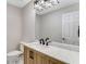 Stylish powder room with a decorative mirror and a wood vanity with marble countertop at 2490 Brookcliff Ne Way, Atlanta, GA 30345