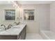 Bathroom features a double vanity, large mirror, modern fixtures, and tub at 2490 Brookcliff Ne Way, Atlanta, GA 30345