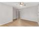 Light-filled bedroom with hardwood floors, ceiling fan, and an open doorway at 2490 Brookcliff Ne Way, Atlanta, GA 30345