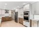 Updated kitchen showcasing white and wood cabinets, stainless appliances including double ovens, and white subway tile backsplash at 2490 Brookcliff Ne Way, Atlanta, GA 30345