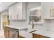 Kitchen detail showing a window view over the farmhouse sink, white countertops, and modern cabinetry at 2490 Brookcliff Ne Way, Atlanta, GA 30345