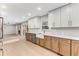 Bright kitchen featuring two-tone cabinets, stainless steel appliances, farmhouse sink, and a view into the living room at 2490 Brookcliff Ne Way, Atlanta, GA 30345