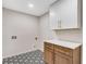 Functional laundry room with decorative tile, modern cabinets and a white countertop at 2490 Brookcliff Ne Way, Atlanta, GA 30345