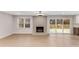 Bright living room featuring a brick fireplace, hardwood floors, and sliding glass doors leading to a deck at 2490 Brookcliff Ne Way, Atlanta, GA 30345