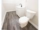 Bright bathroom featuring modern vanity and toilet with wood-look flooring at 557 Old Friar Tuck Ln, Stone Mountain, GA 30087