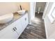 Stylish bathroom with wood-look tile flooring, double sinks, and modern fixtures at 557 Old Friar Tuck Ln, Stone Mountain, GA 30087