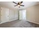 Bedroom with carpet, ceiling fan, and doorways to other rooms at 557 Old Friar Tuck Ln, Stone Mountain, GA 30087