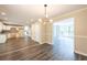 Open floorplan featuring luxury vinyl plank flooring and a modern light fixture at 557 Old Friar Tuck Ln, Stone Mountain, GA 30087