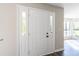 Elegant white front door with sidelights, leading into a welcoming foyer area at 557 Old Friar Tuck Ln, Stone Mountain, GA 30087